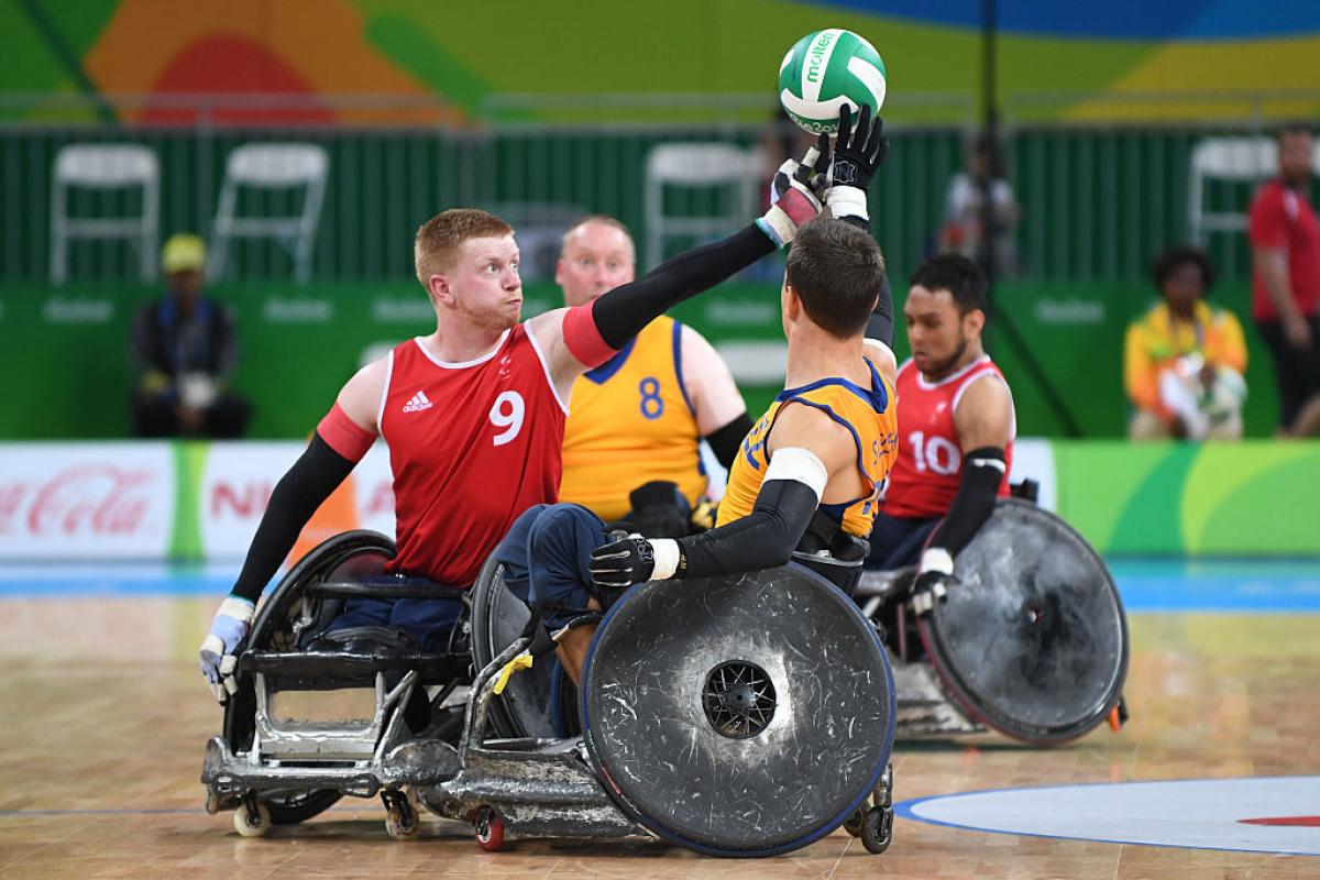 two men contesting the ball in wheelchairs