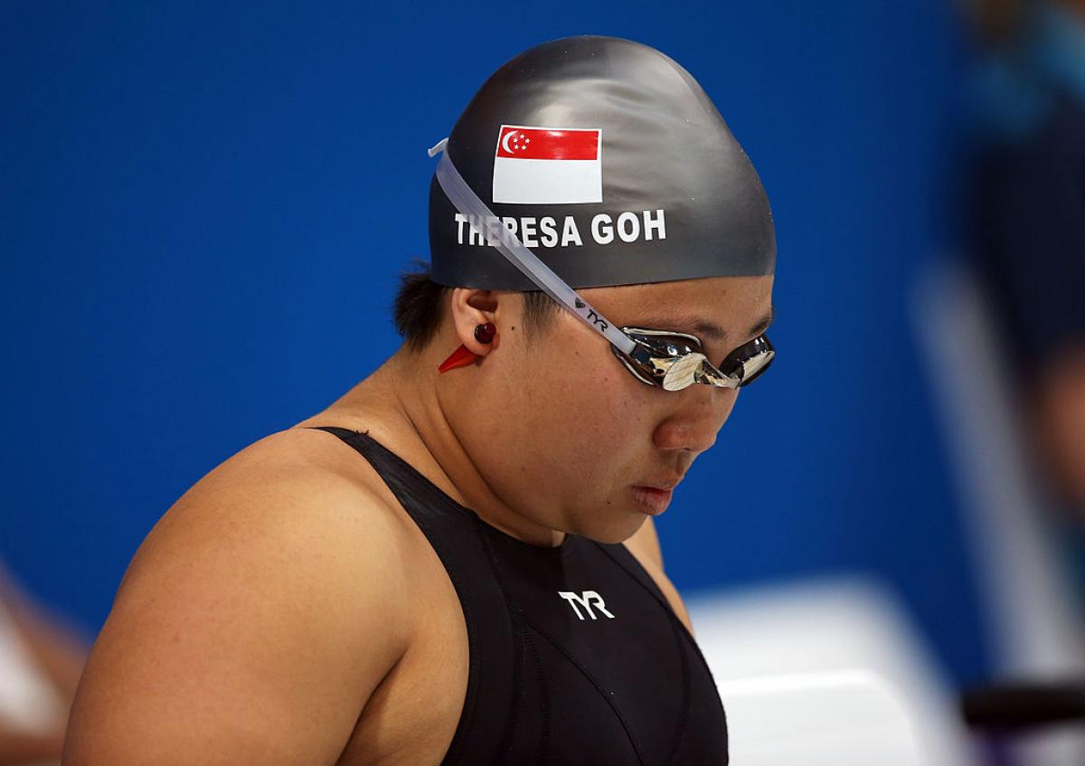 a woman with swimming cap and goggles on 