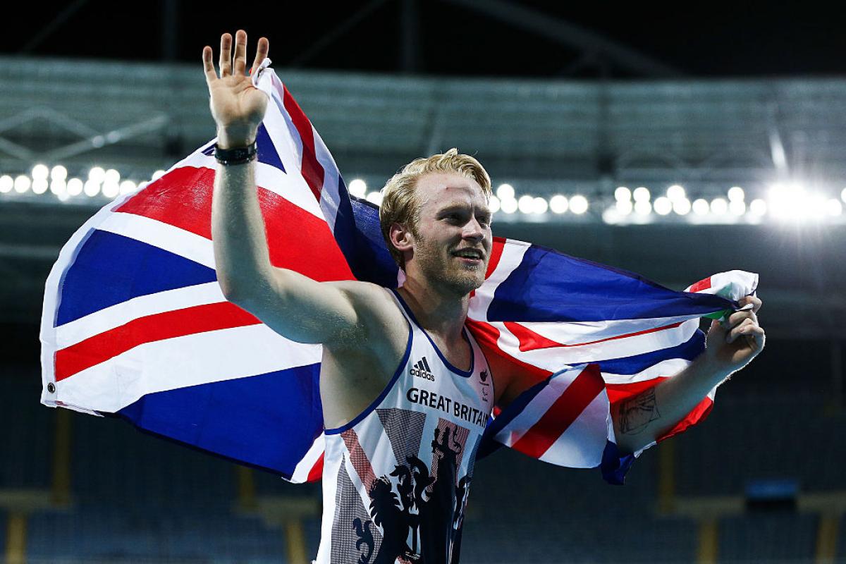 man runs with a British flag