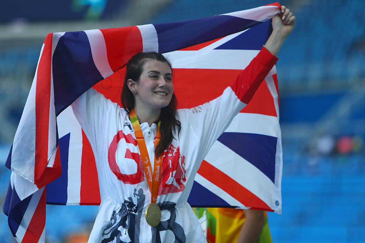 a woman holds up a flag