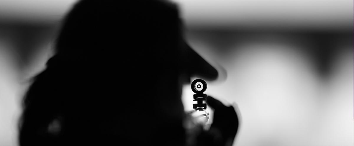 a blacked out shot of a rifle focusing on a target