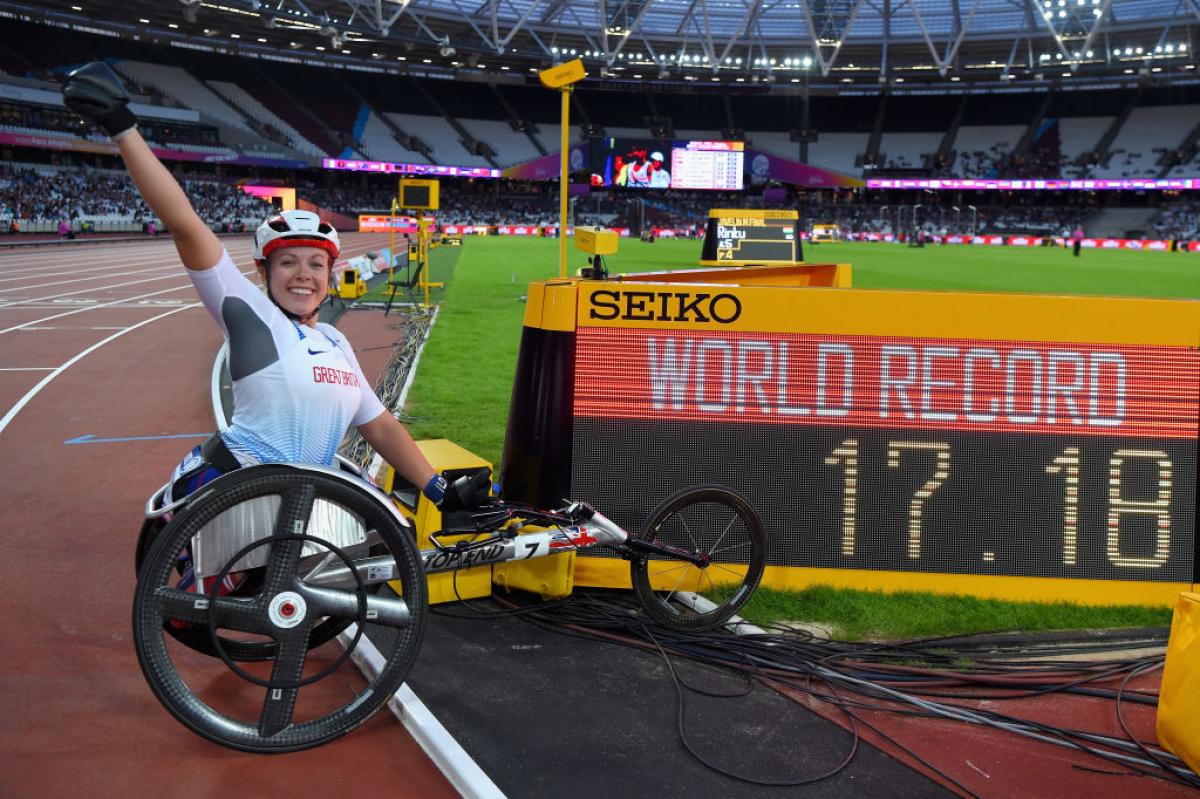 Hannah Cockroft - Great Britain - London 2017 Woman in racing wheelchair next to a screen