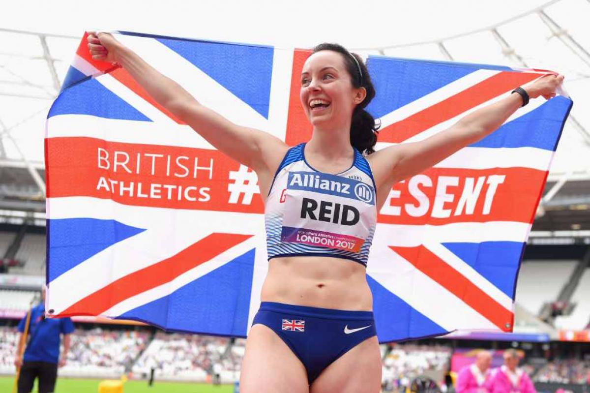 a para athlete holds a British flag