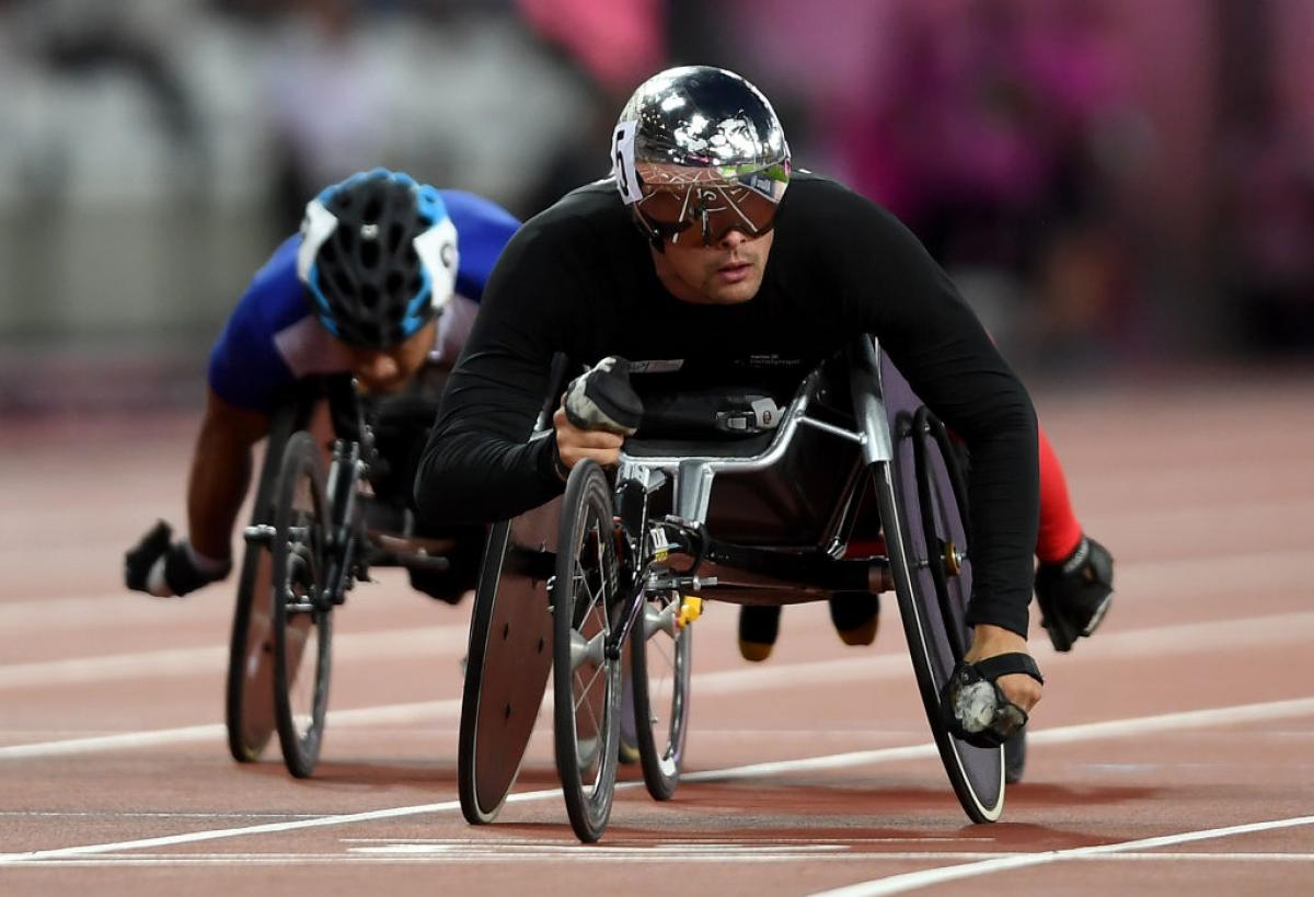 a wheelchair racer crosses the finish line