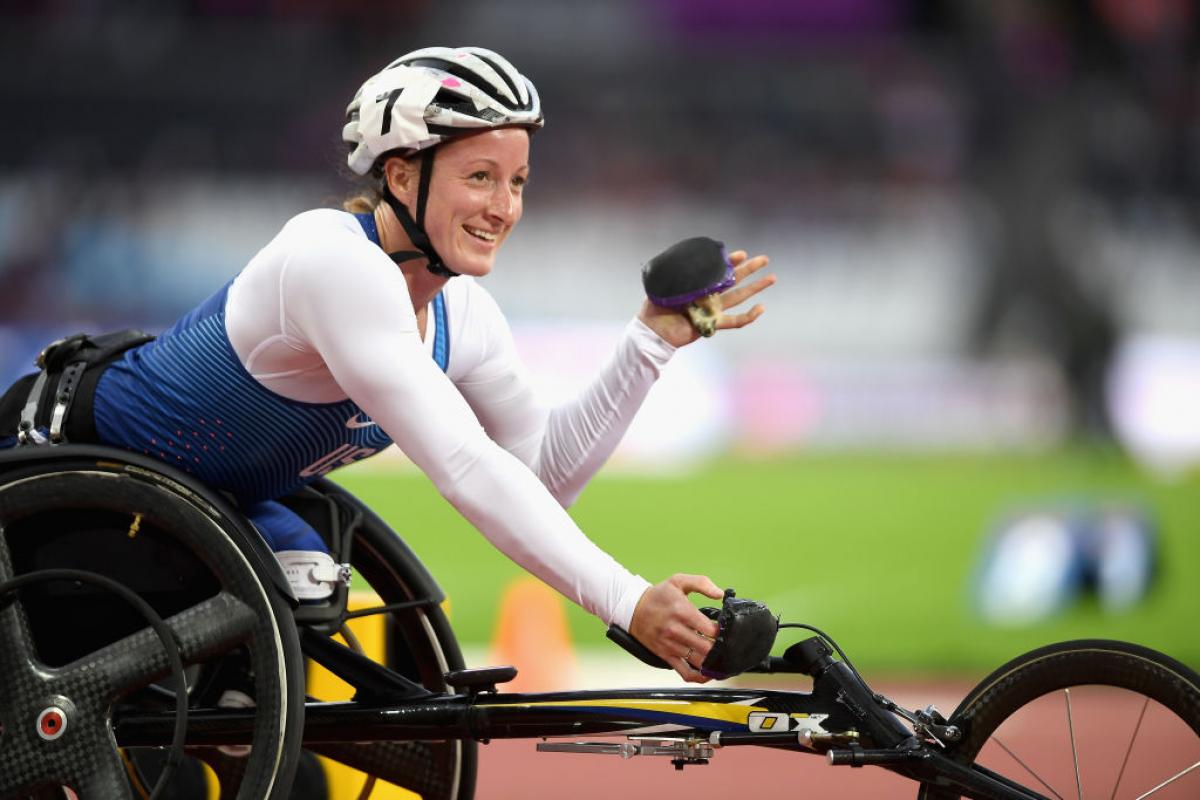 a wheelchair racer celebrates winning her race