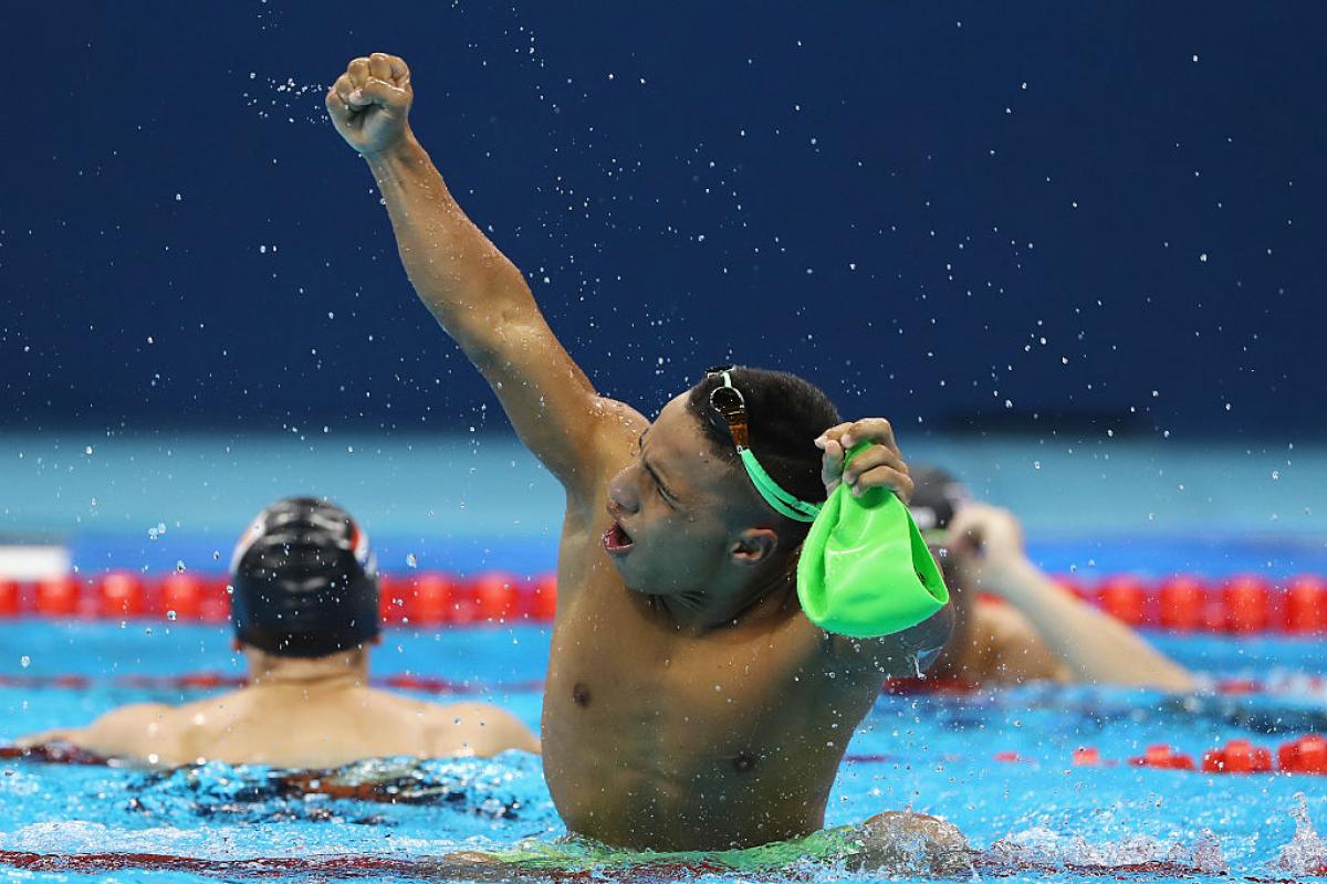 a para swimmer celebrates in the pool