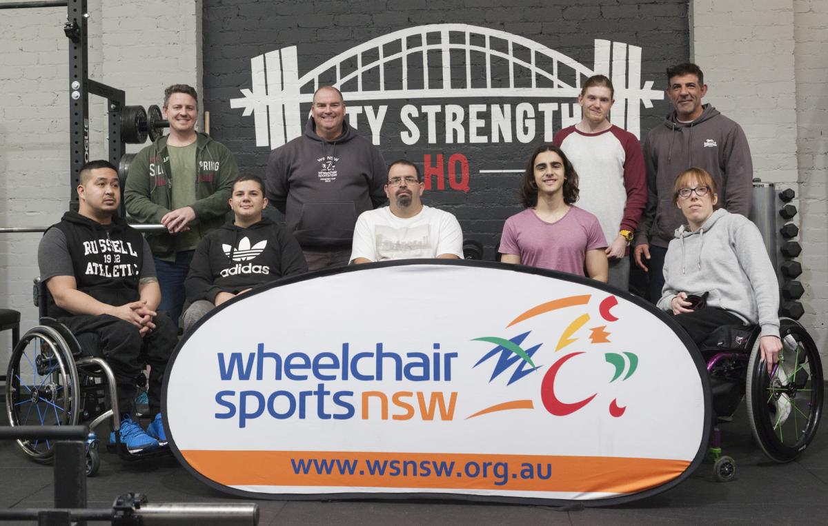 a group of powerlifters pose for a photo
