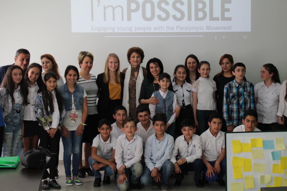 a group of schoolchildren pose for a photo 