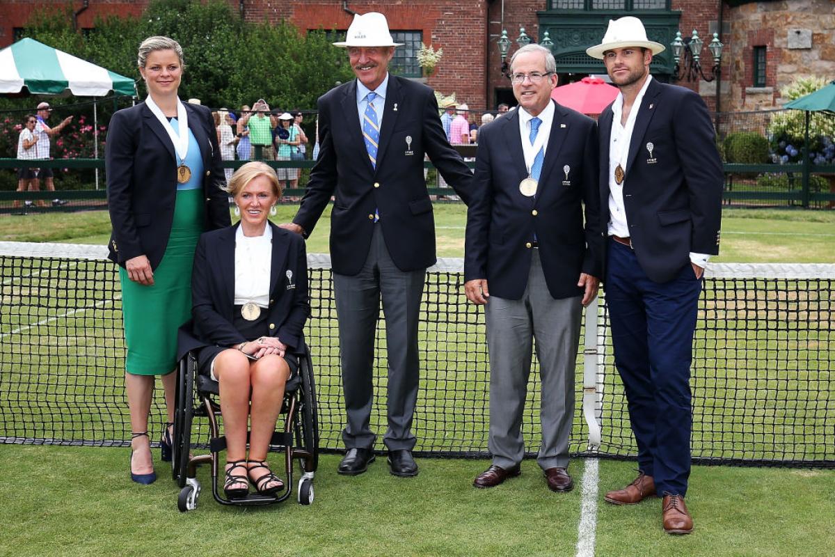 Monique Kalkman-van den Bosch - Hall of Fame 2017 a woman in a wheelchair speaks to a crowd of people