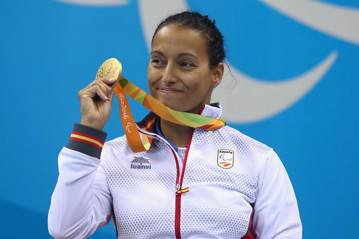 a Para swimmer celebrates with her medal