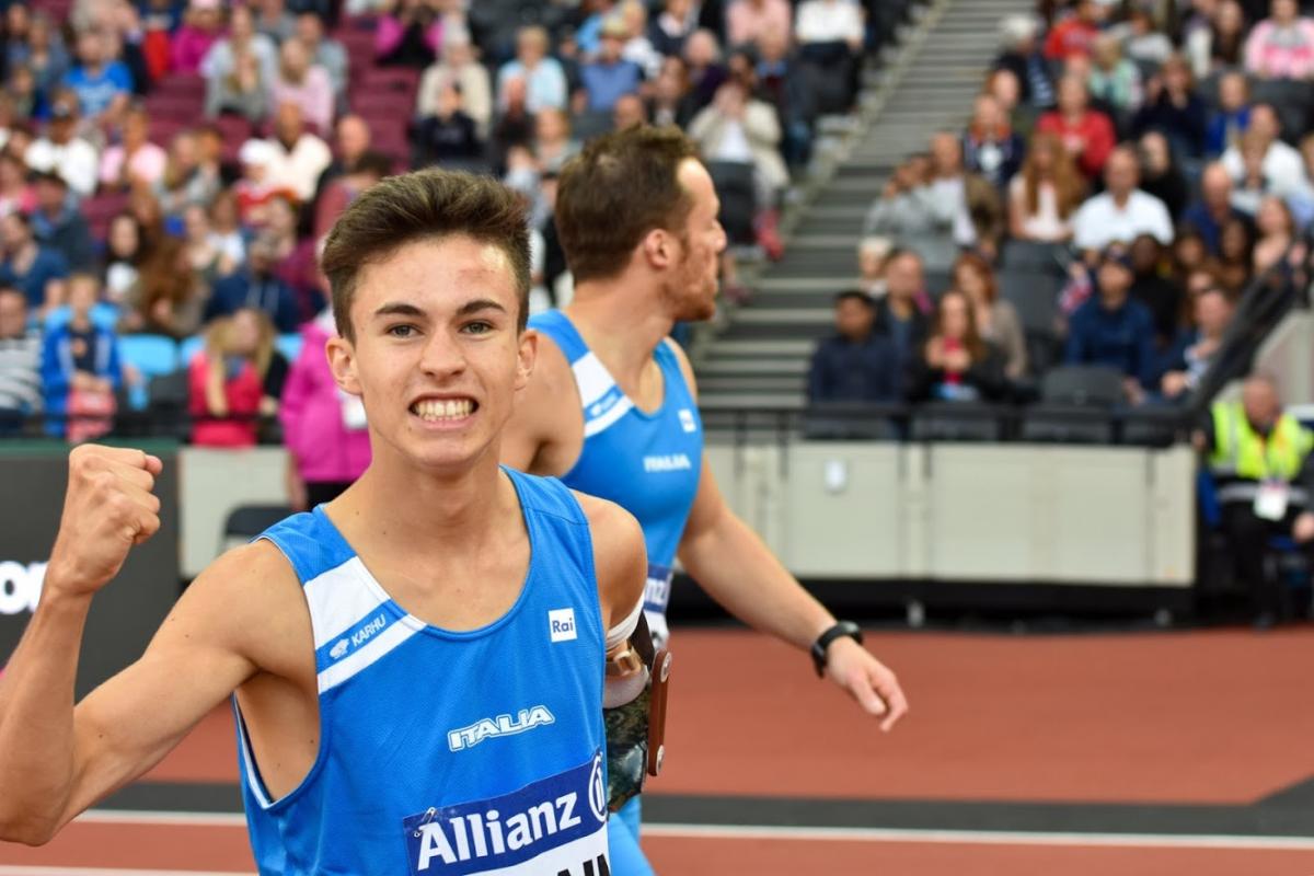 a para athlete celebrates by shaking his fist