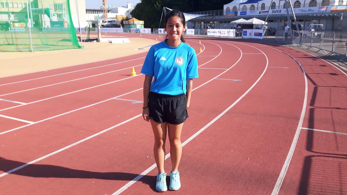 a female para athlete smiles for the camera