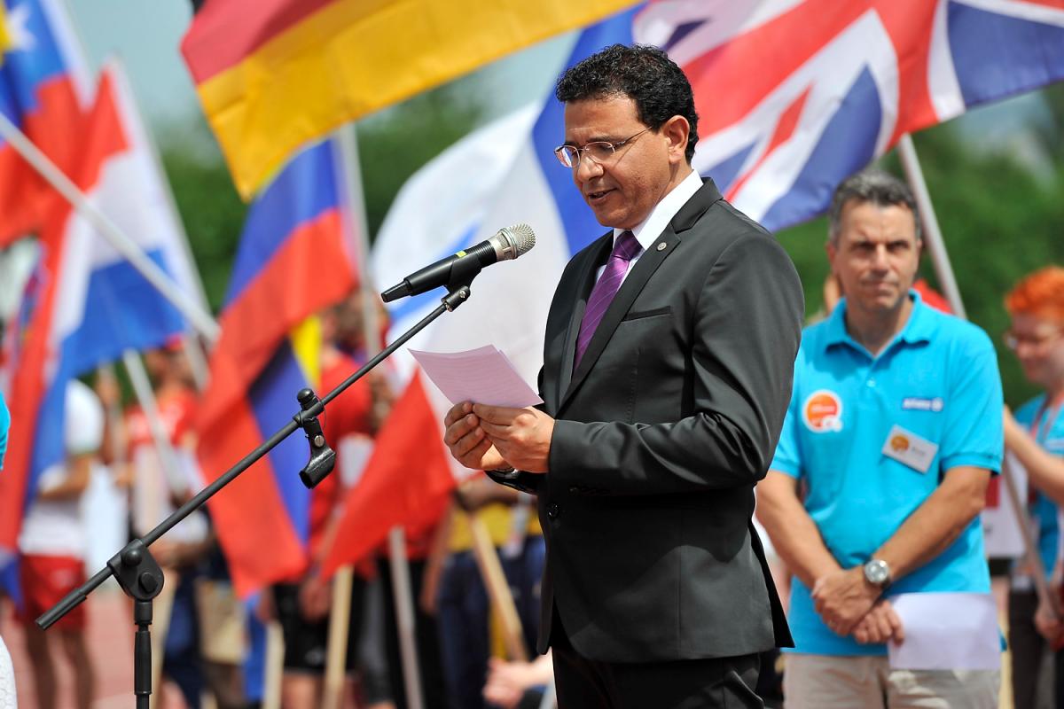 a man speaks at a podium