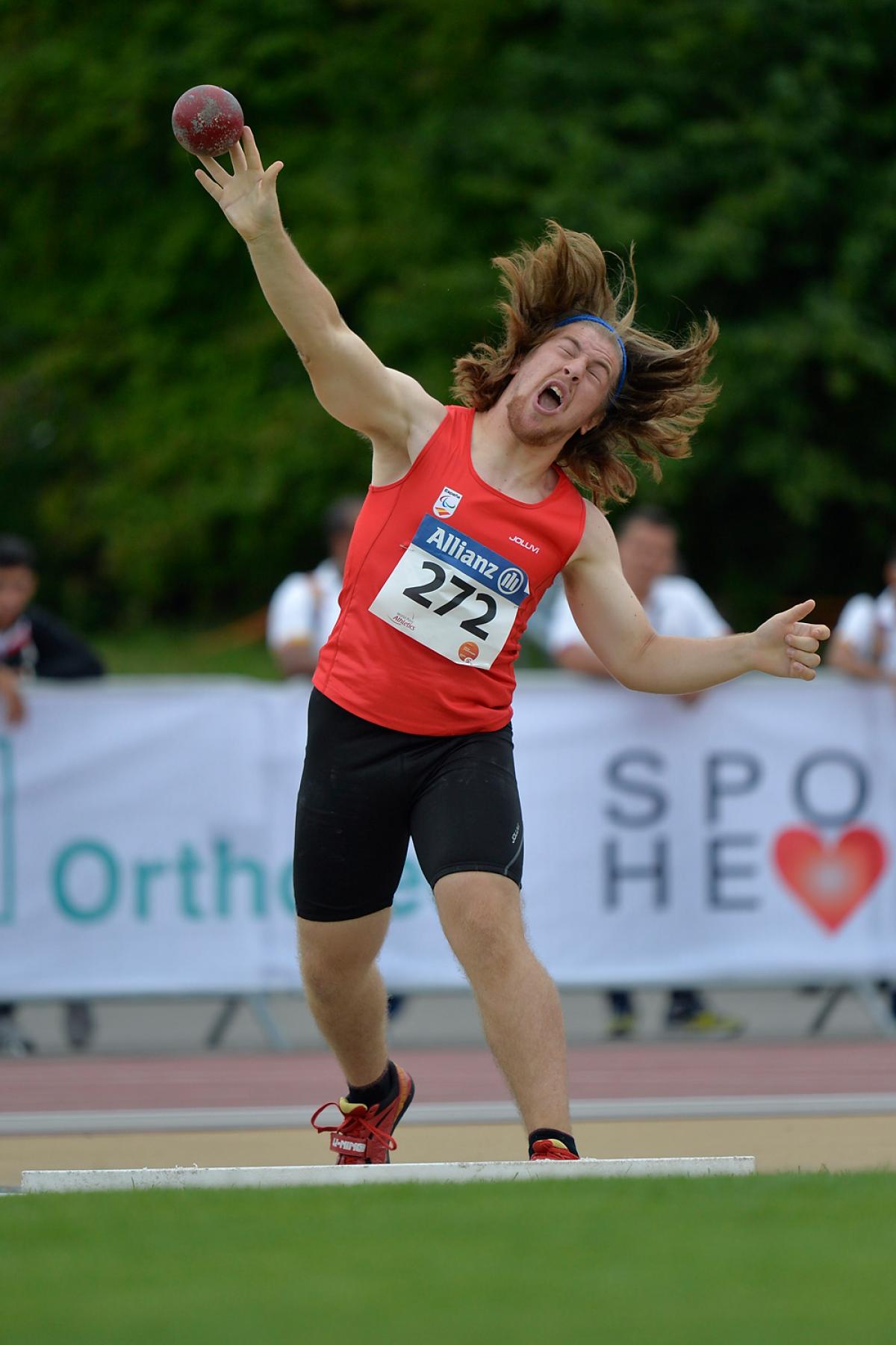 Athlete throws a shot put