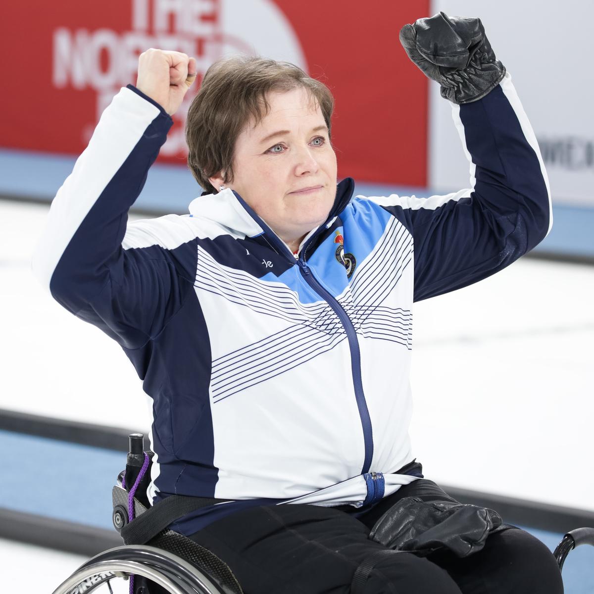 Female wheelchair curler raises her arms