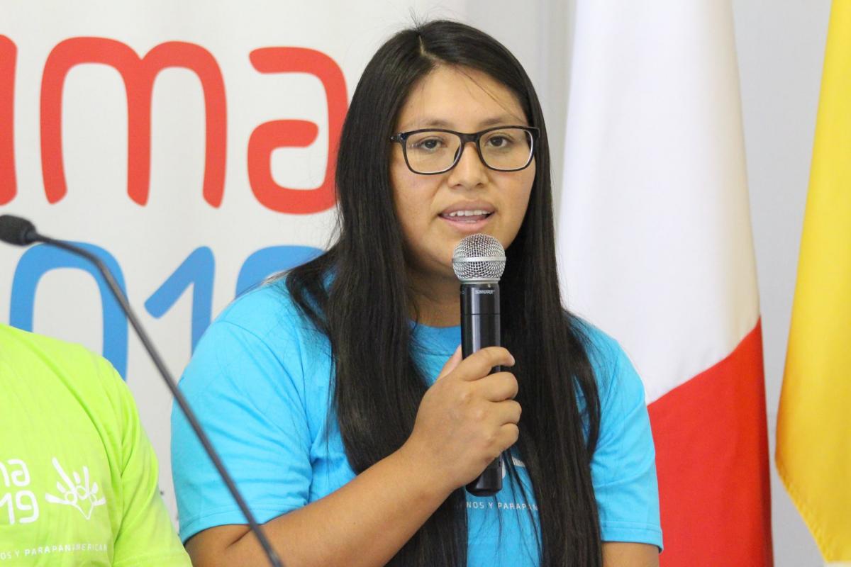 Pilar Jauregui - Lima 2019 ambassador a female Para athlete speaks into a microphone