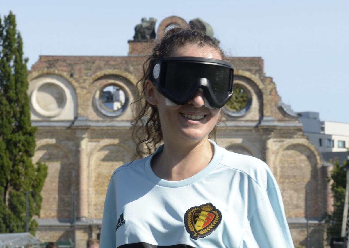 a female blind footballer smiles for the camera