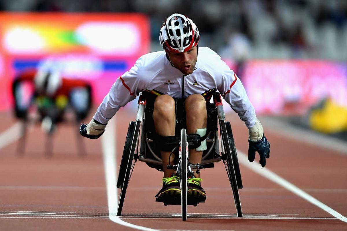 a male wheelchair racer sprints for the line