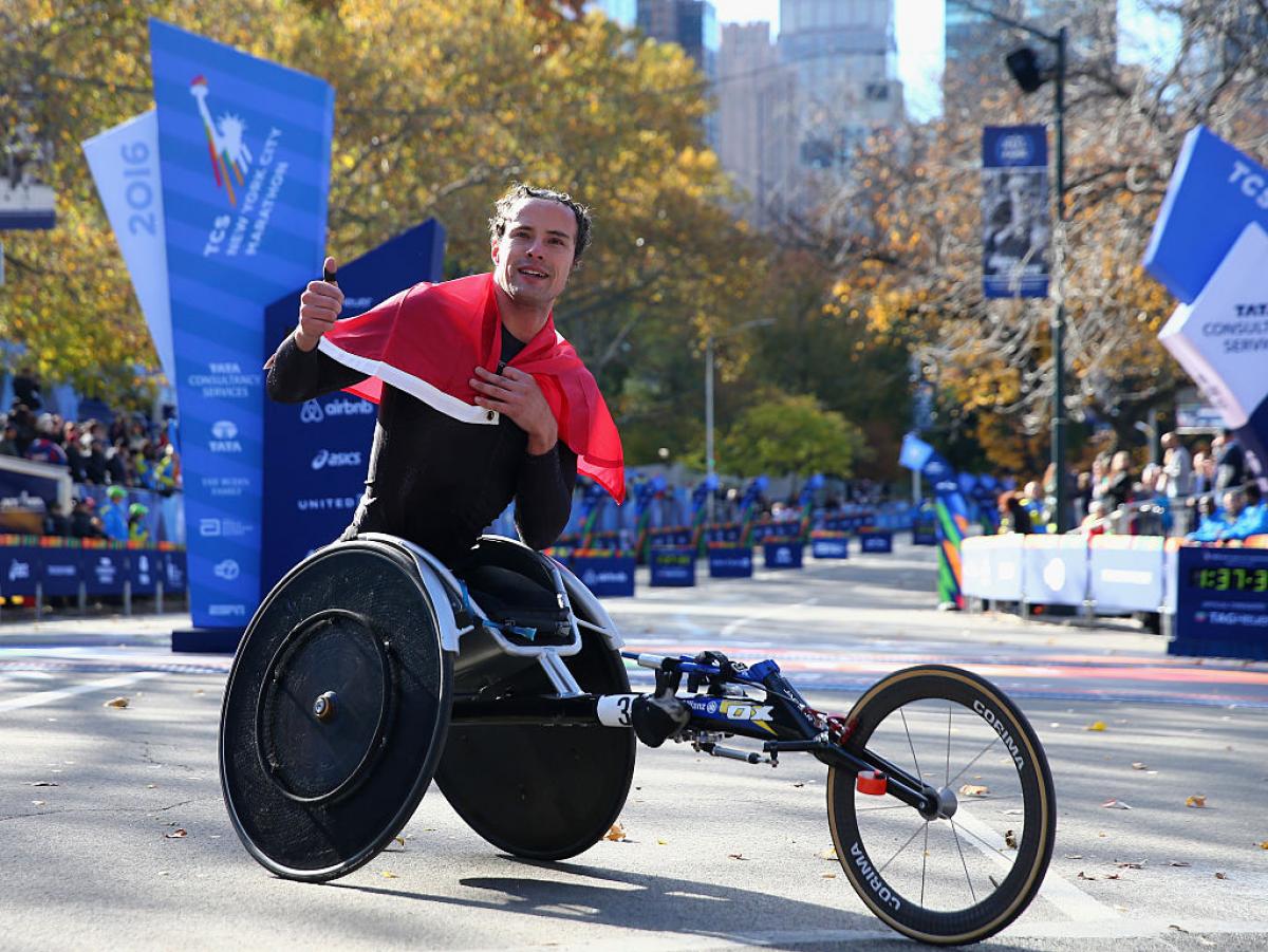 Marcel Hug - New York Marathon 2016 a male wheelchair athlete celebrates his win