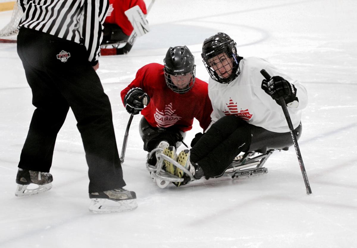 Canada women's Para ice hockey trials two female Para ice hockey players are given instructions on the ice