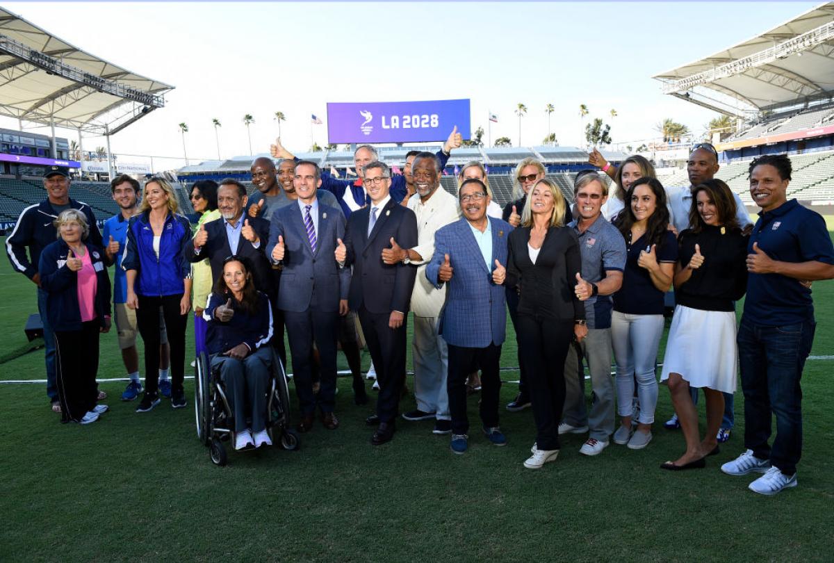 LA 2028 a group of people smiling in a stadium
