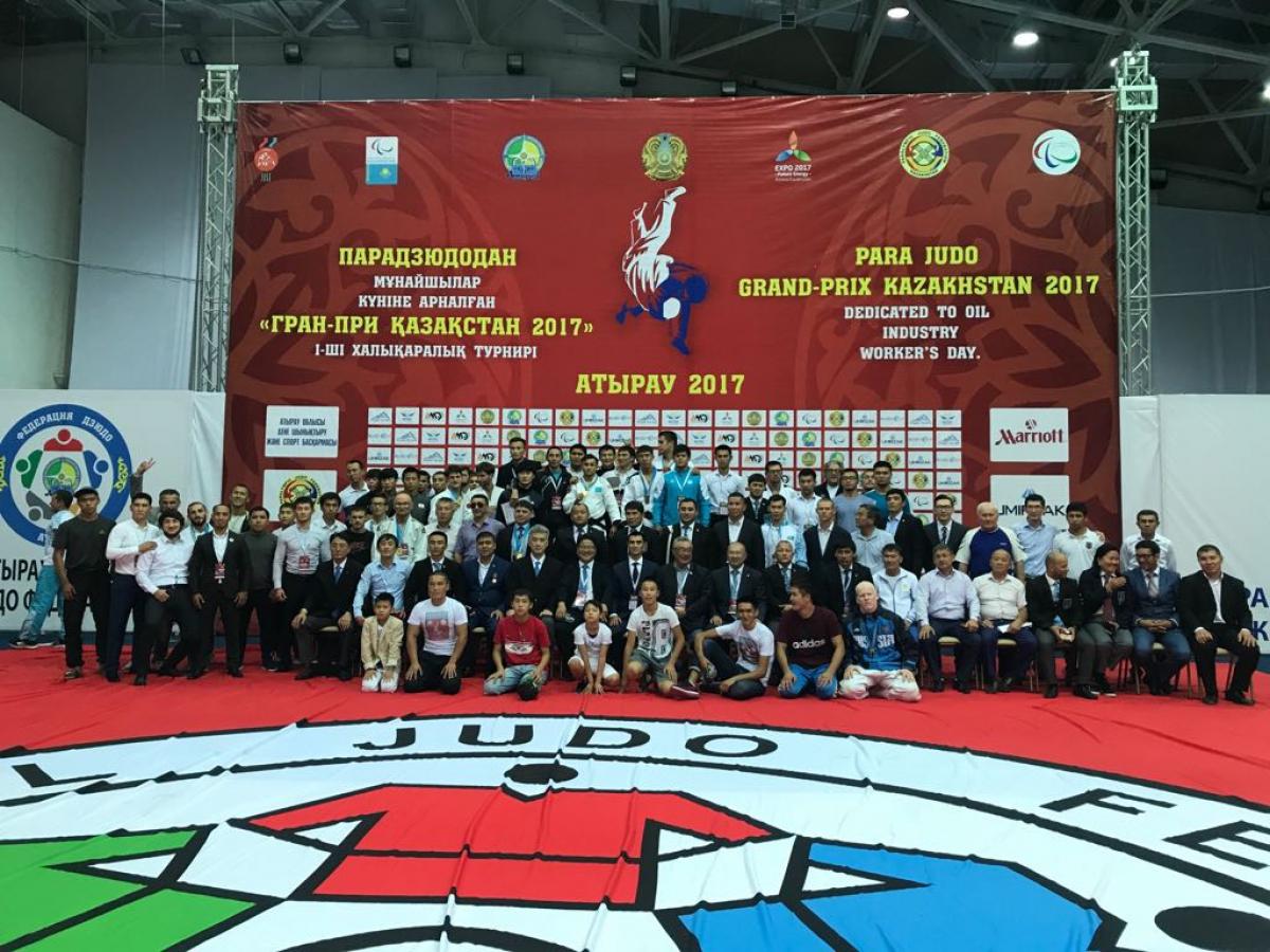Group of people from a judo event pose for a photo