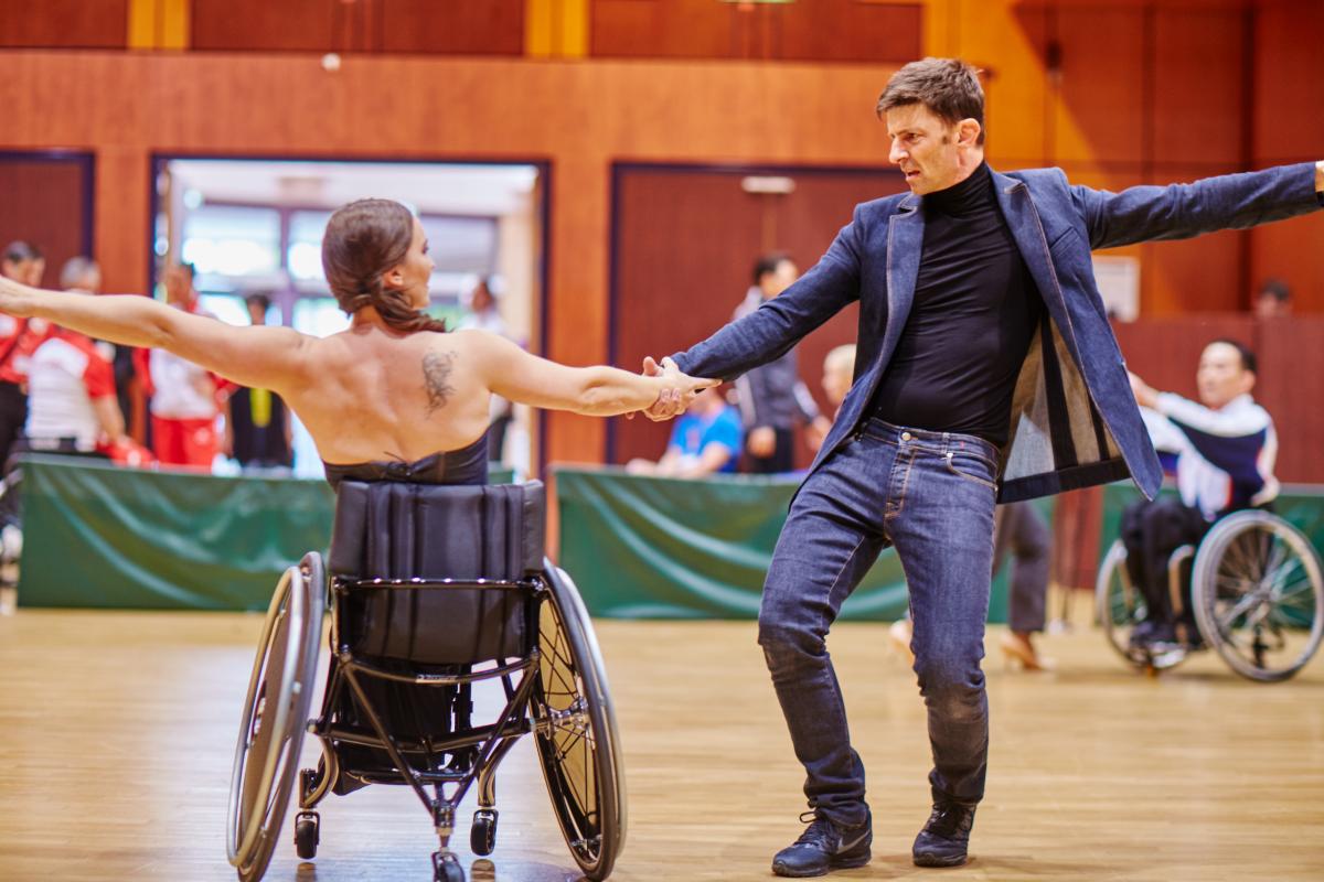 Woman wheelchair dancer and her standing partner perform 