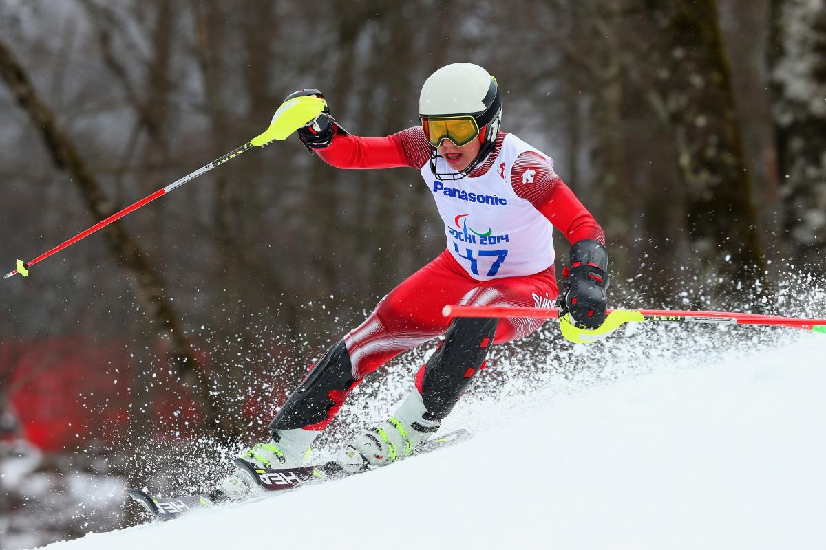 a male Para skier goes down the slope