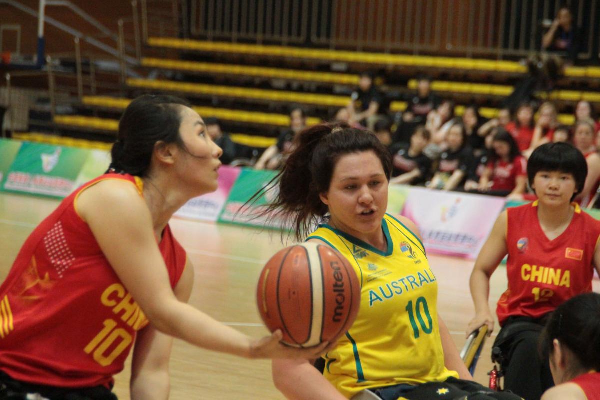 female wheelchair basketball players battle for the ball