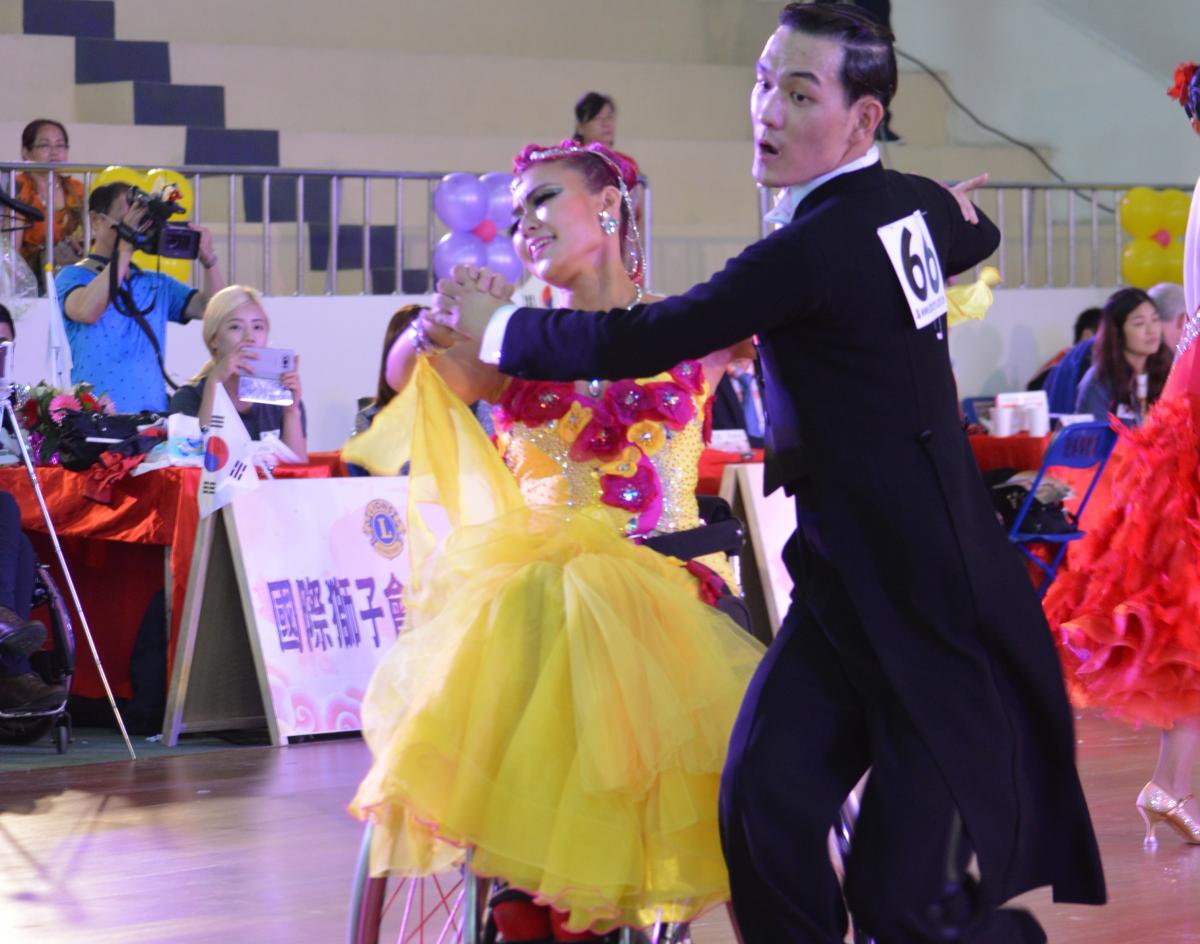 a Para dance couple perform a move