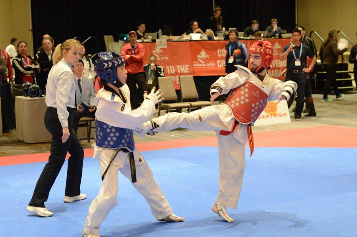 two Para taekwondo fighters on the mat