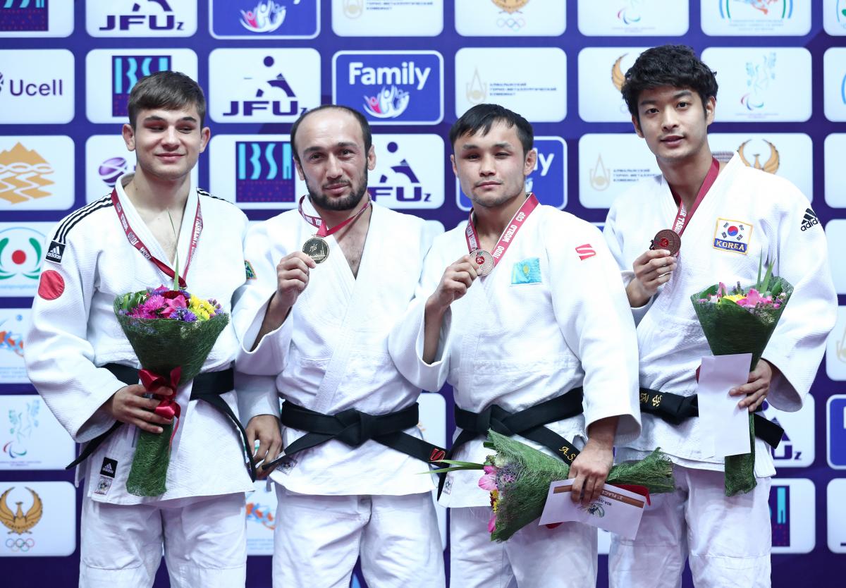 Sherzod Namozov four Para judokas stand on the podium with their medals