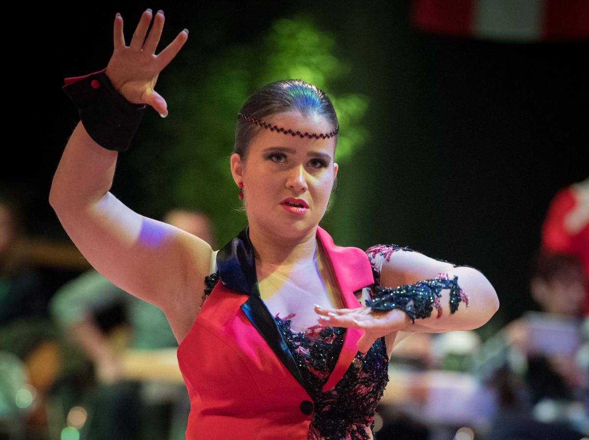 a female Para dance athlete shapes her arms
