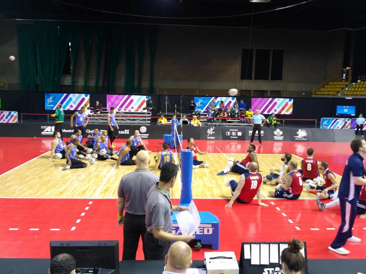 Brazil v USA - ParaVolley Pan America Championships two sitting volleyball teams on the court ready to begin play