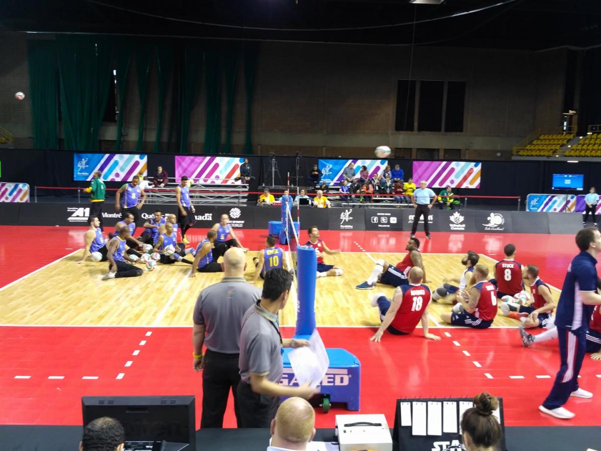 two sitting volleyball teams on the court ready to begin play