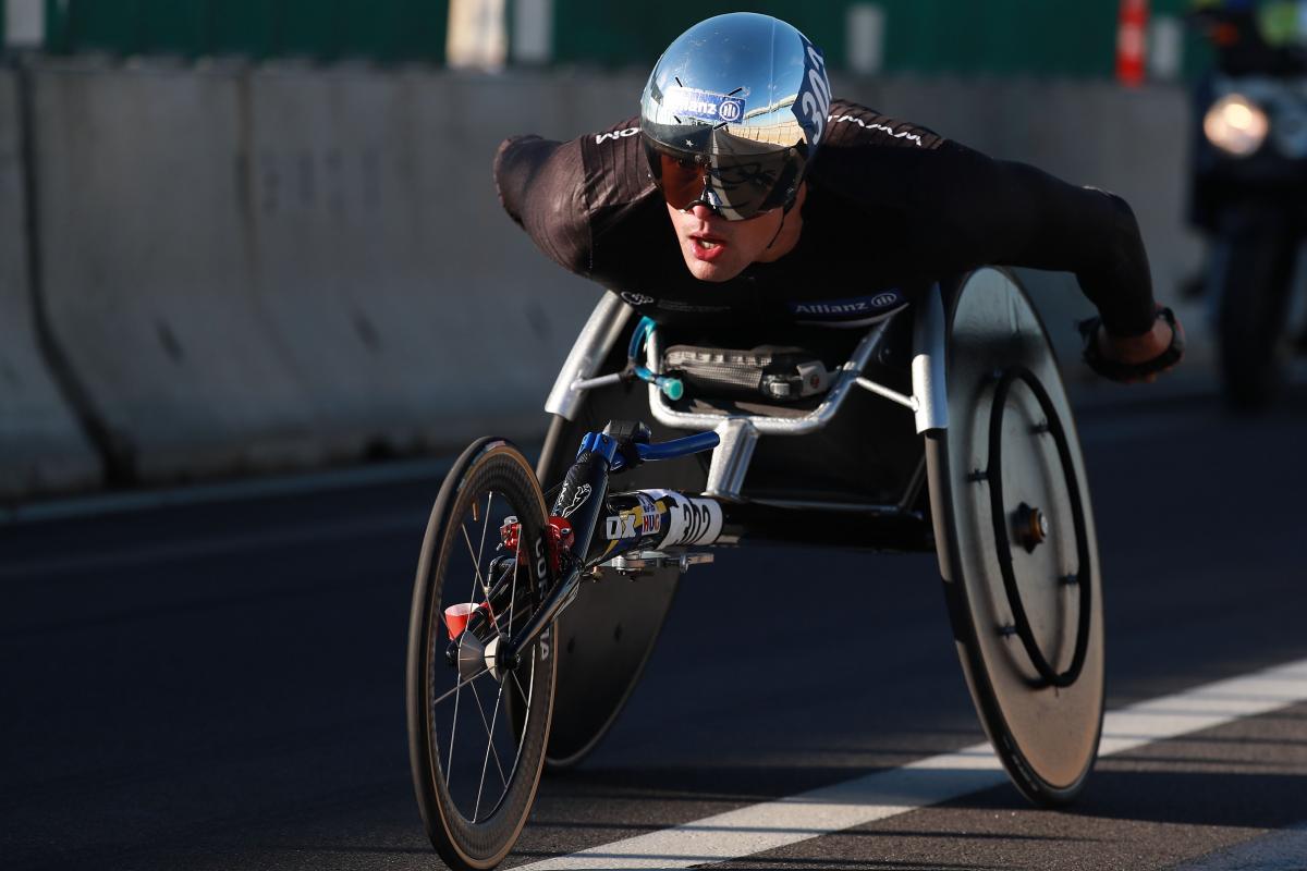 a male wheelchair racer on the road