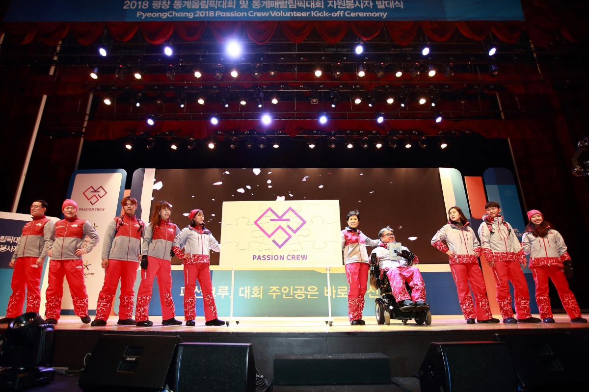 a group of people model outfits on a stage