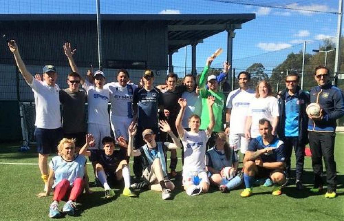 a group of blind footballers smile at the camera