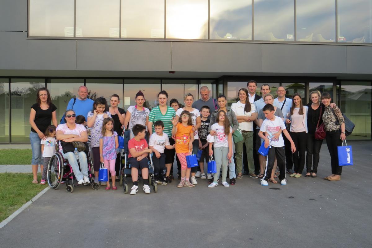 a group of adults and children smile for the camera