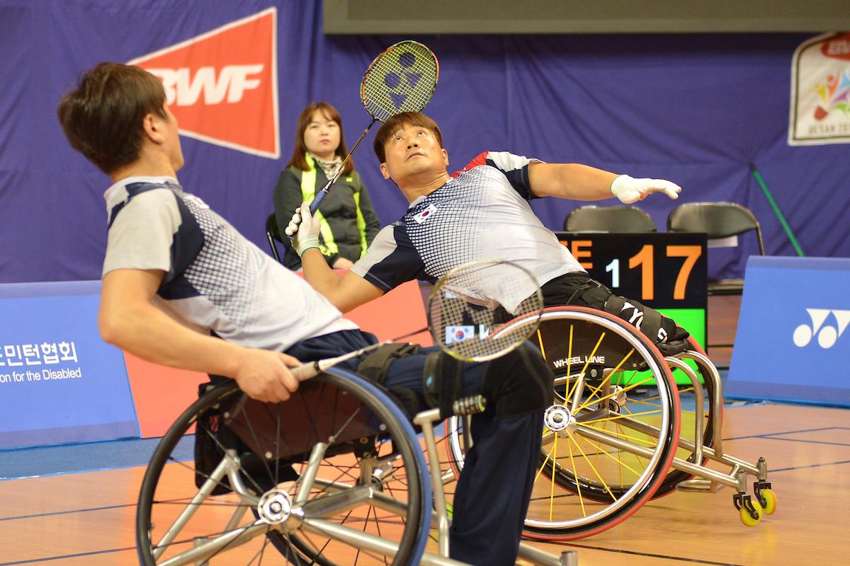 two male Para badminton players on the court