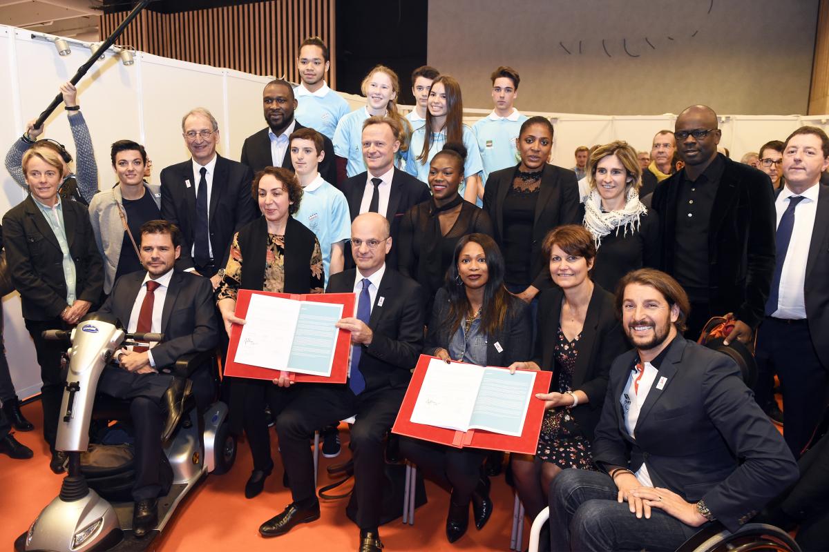 Paris 2024 education week a group of people smile for the camera