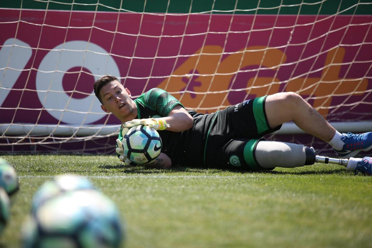 Person with a prosthetic leg practicing football as a goalkeeper