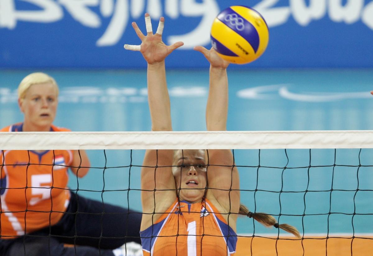 Elvira Stinissen a female sitting volleyball player tries to block a spike