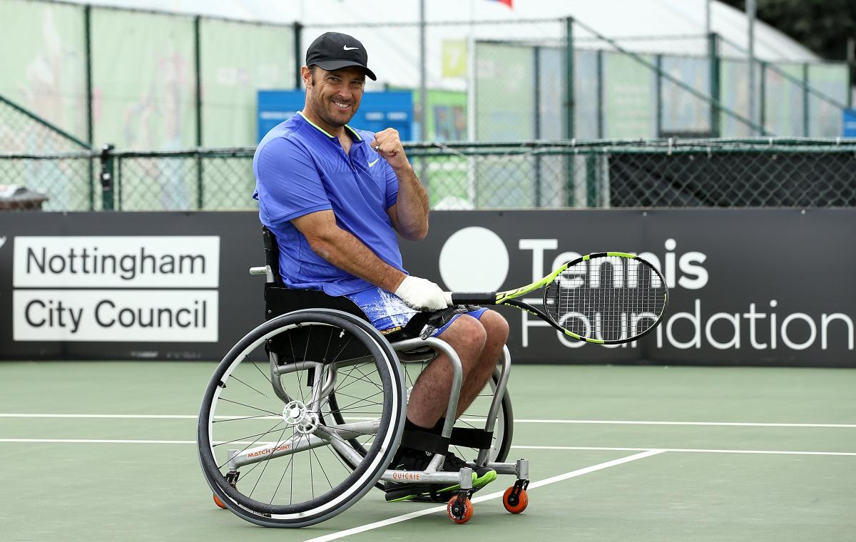 a male wheelchair tennis player gives a fist pump