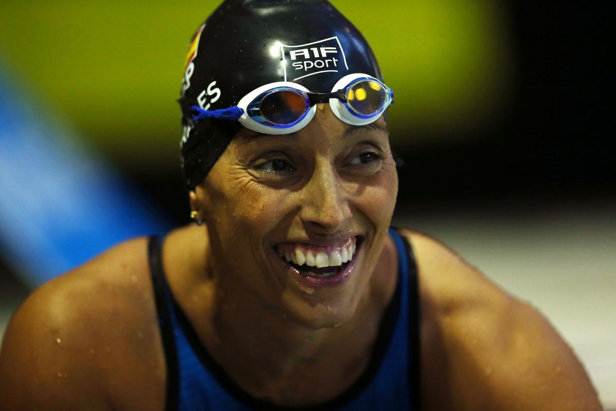 a female Para swimmer smiling in the pool