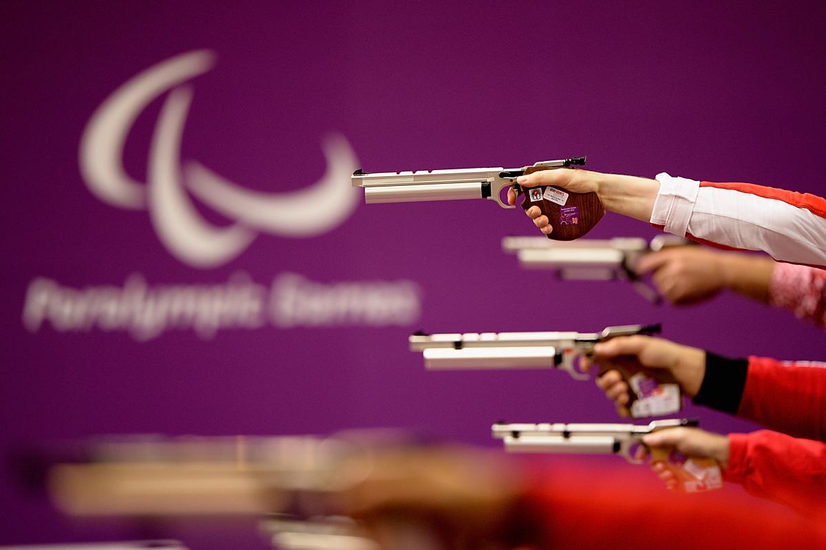 View down the line of pistol shooters in action