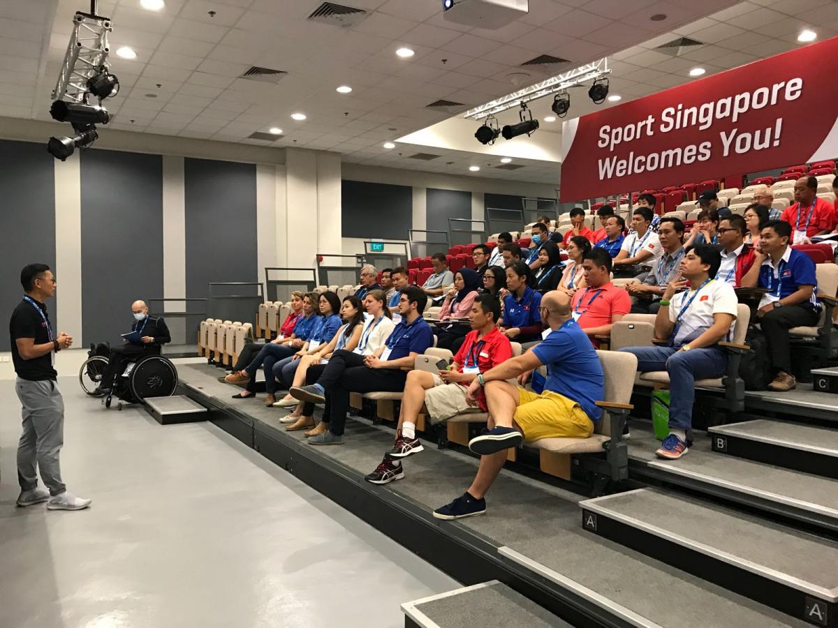 Educator delivers course to audience of coaches and classifiers