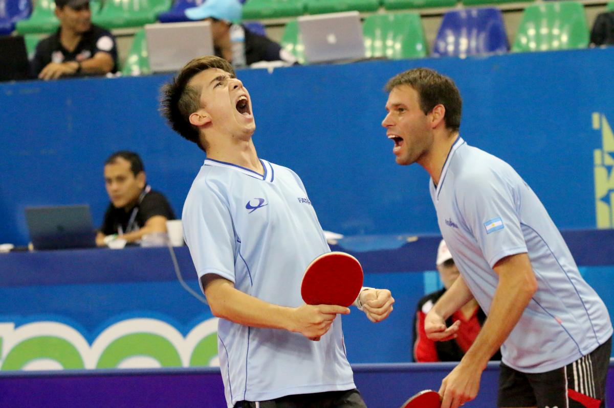 male Para table tennis players celebrate a point