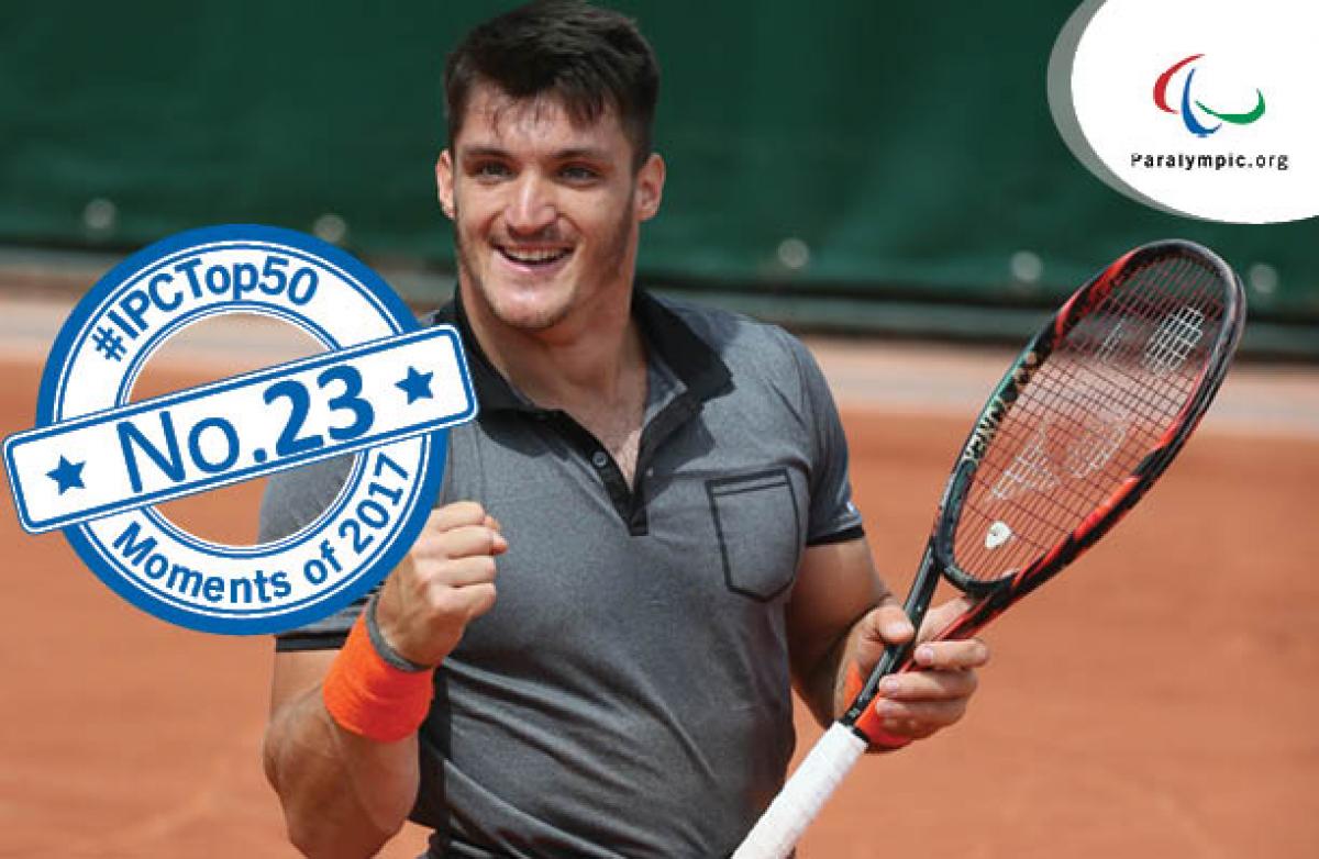 a male wheelchair tennis player celebrates winning a point