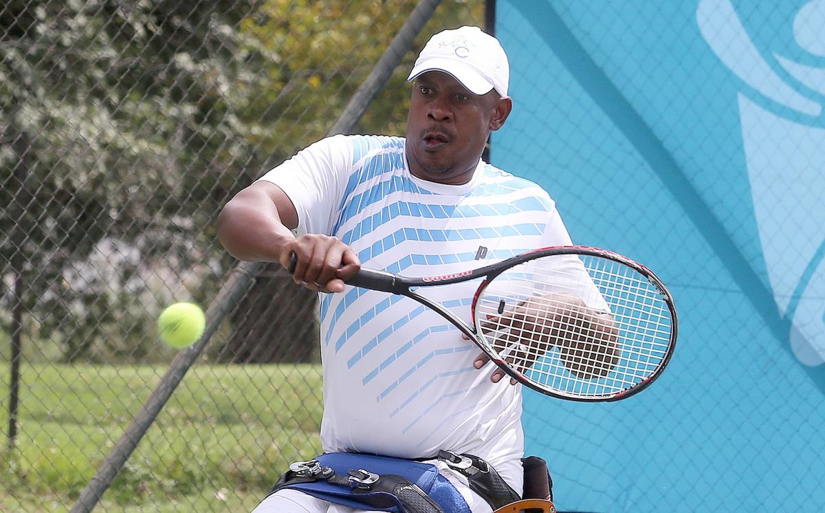 Patrick Selepe a male wheelchair tennis player takes a shot